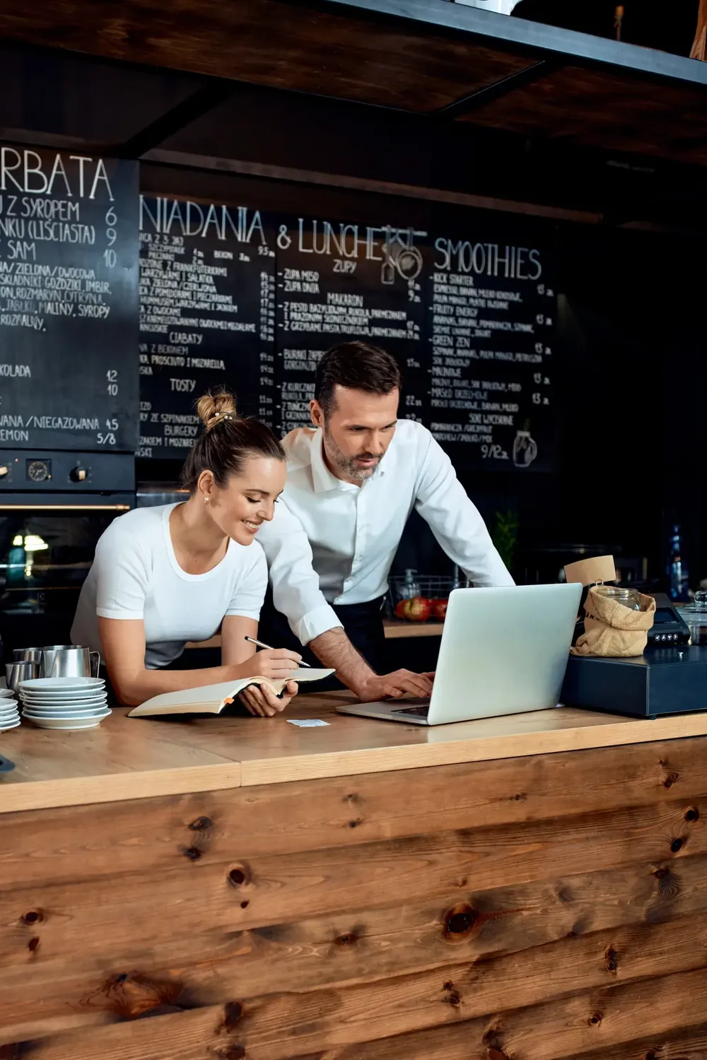 Business owners viewing a website on a laptop