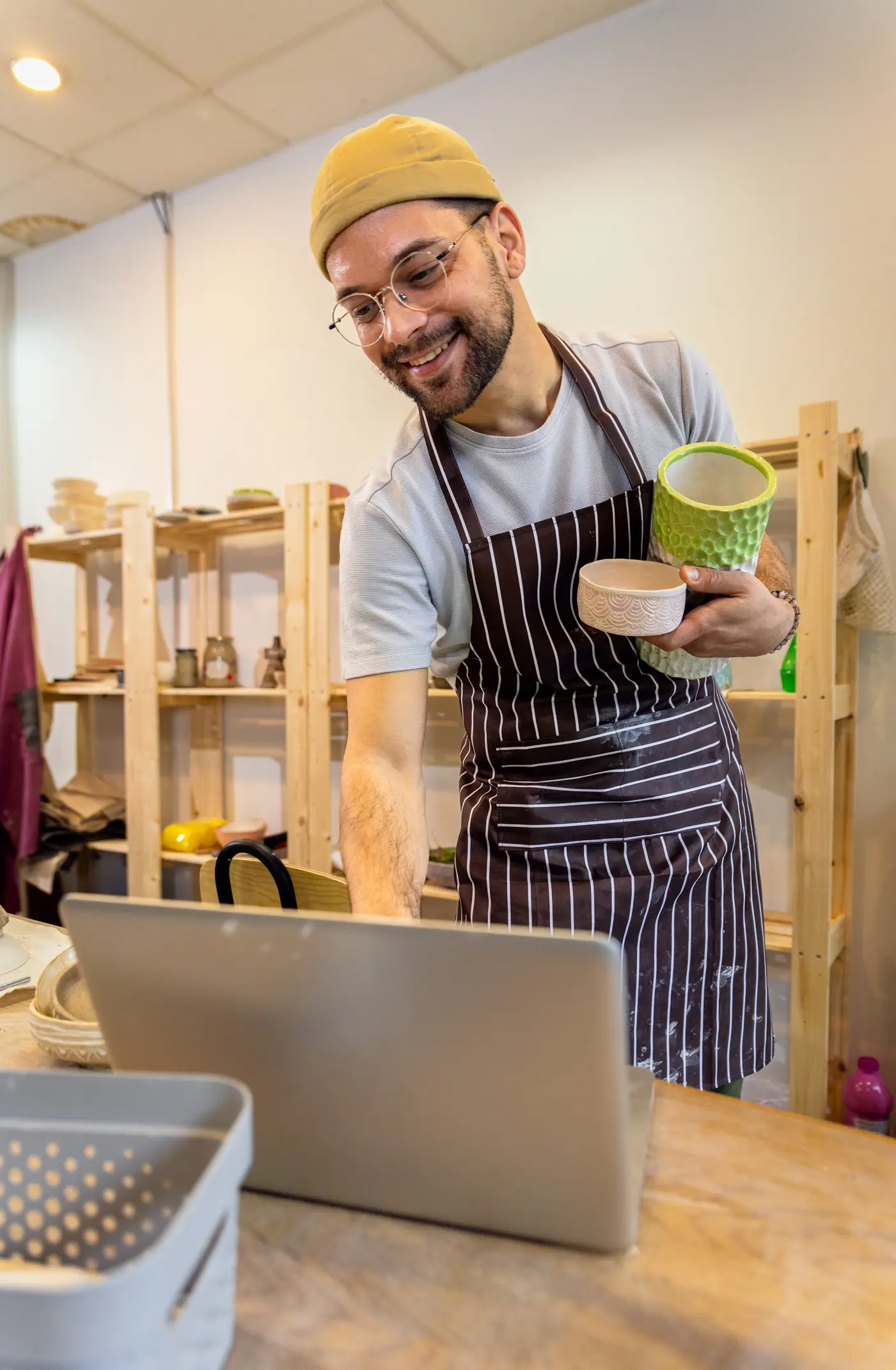 Smiling business owner viewing laptop
