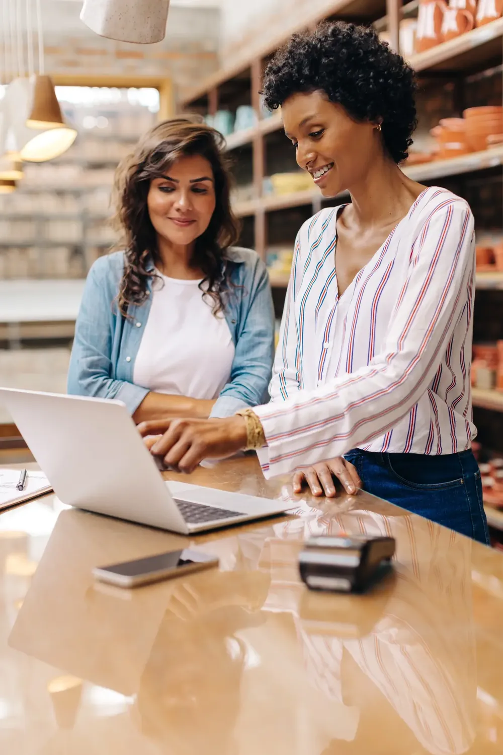 Two women working together on their business