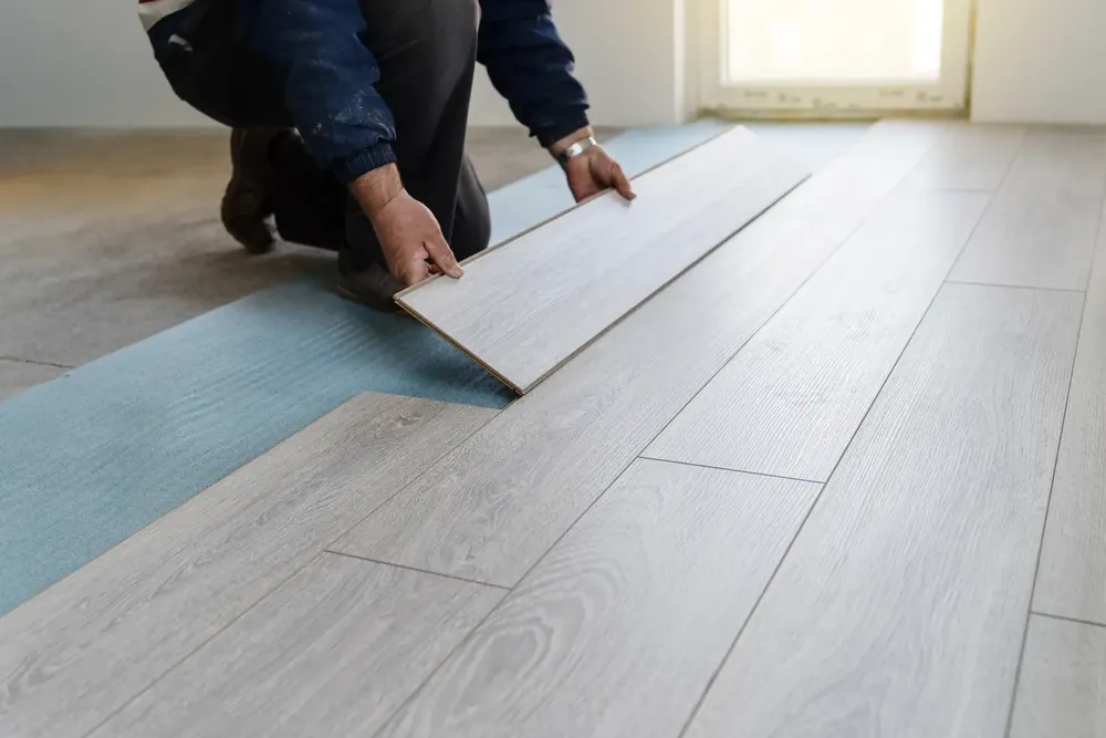 Tradesman working on flooring a home