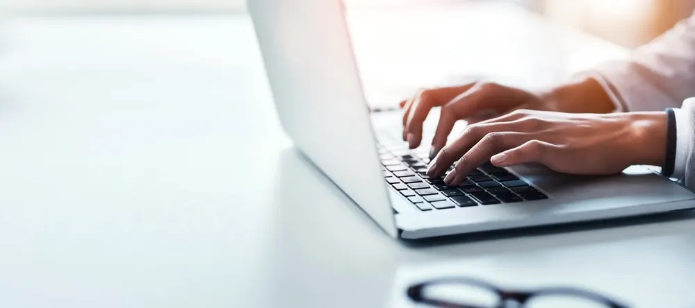 Person typing on a laptop