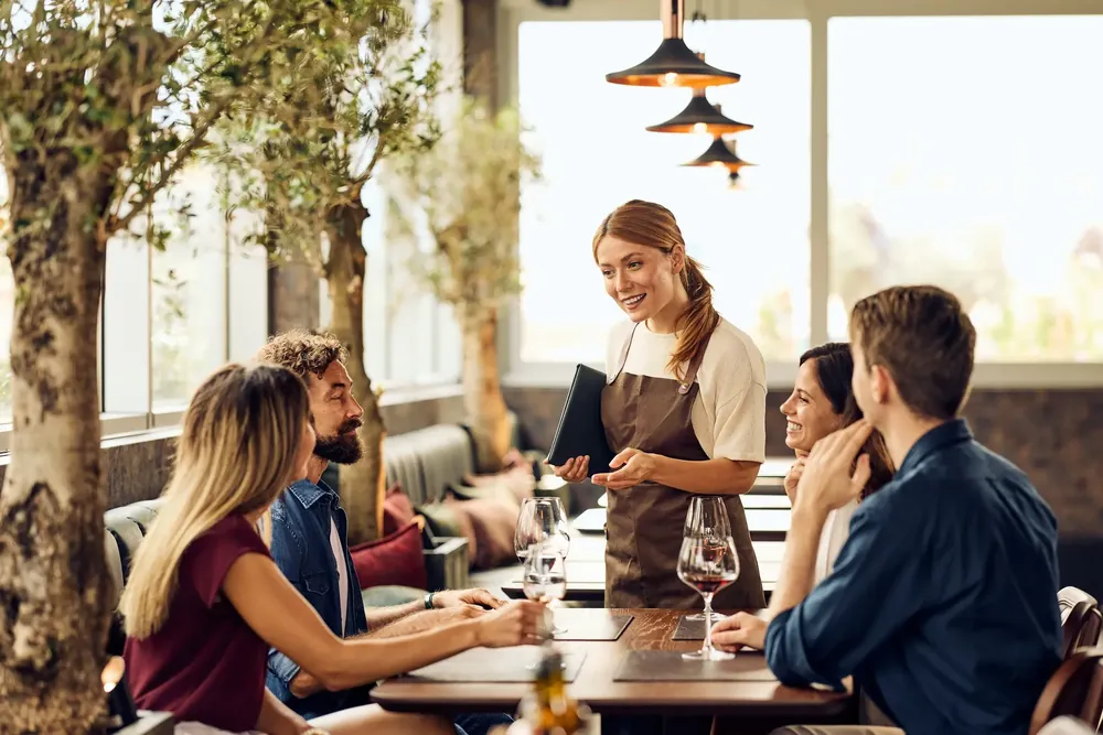 Restaurant waitress serving a table of people