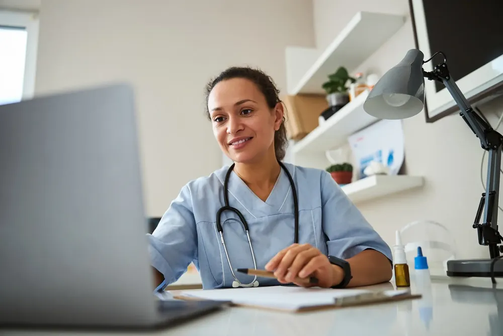 Doctor on a laptop computer viewing her website