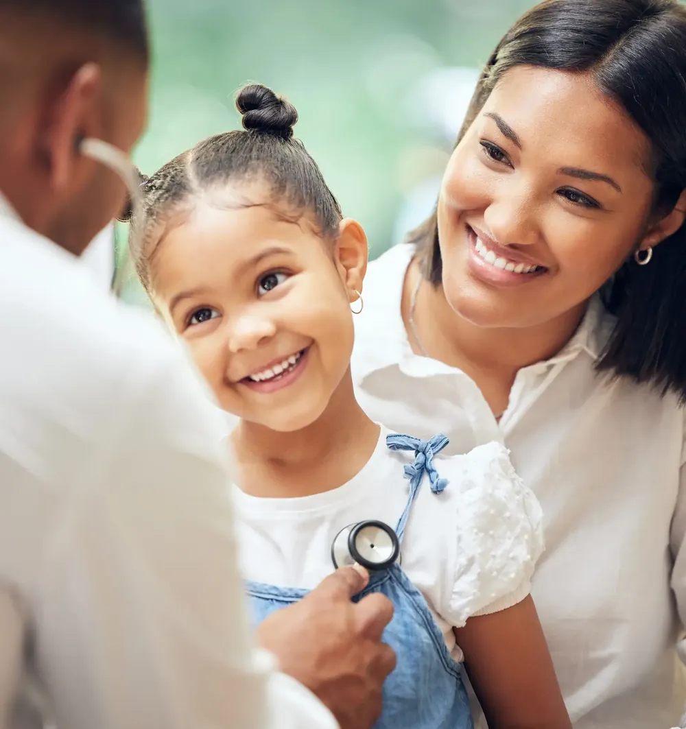 Doctor listening to a child's heartbeat