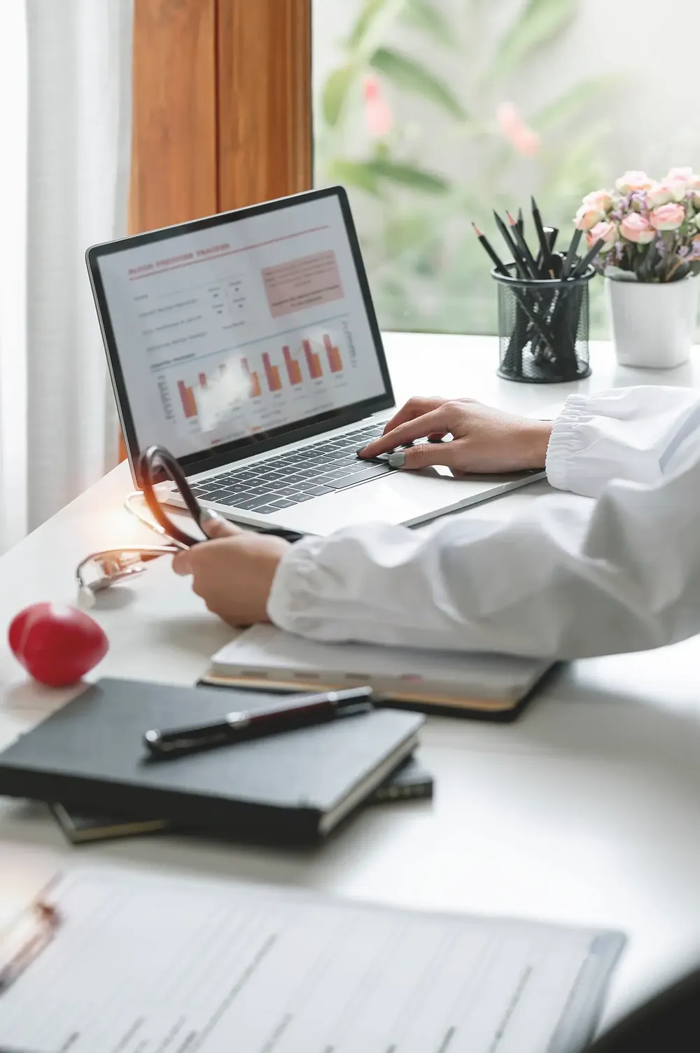 Doctor reviewing their website on a laptop