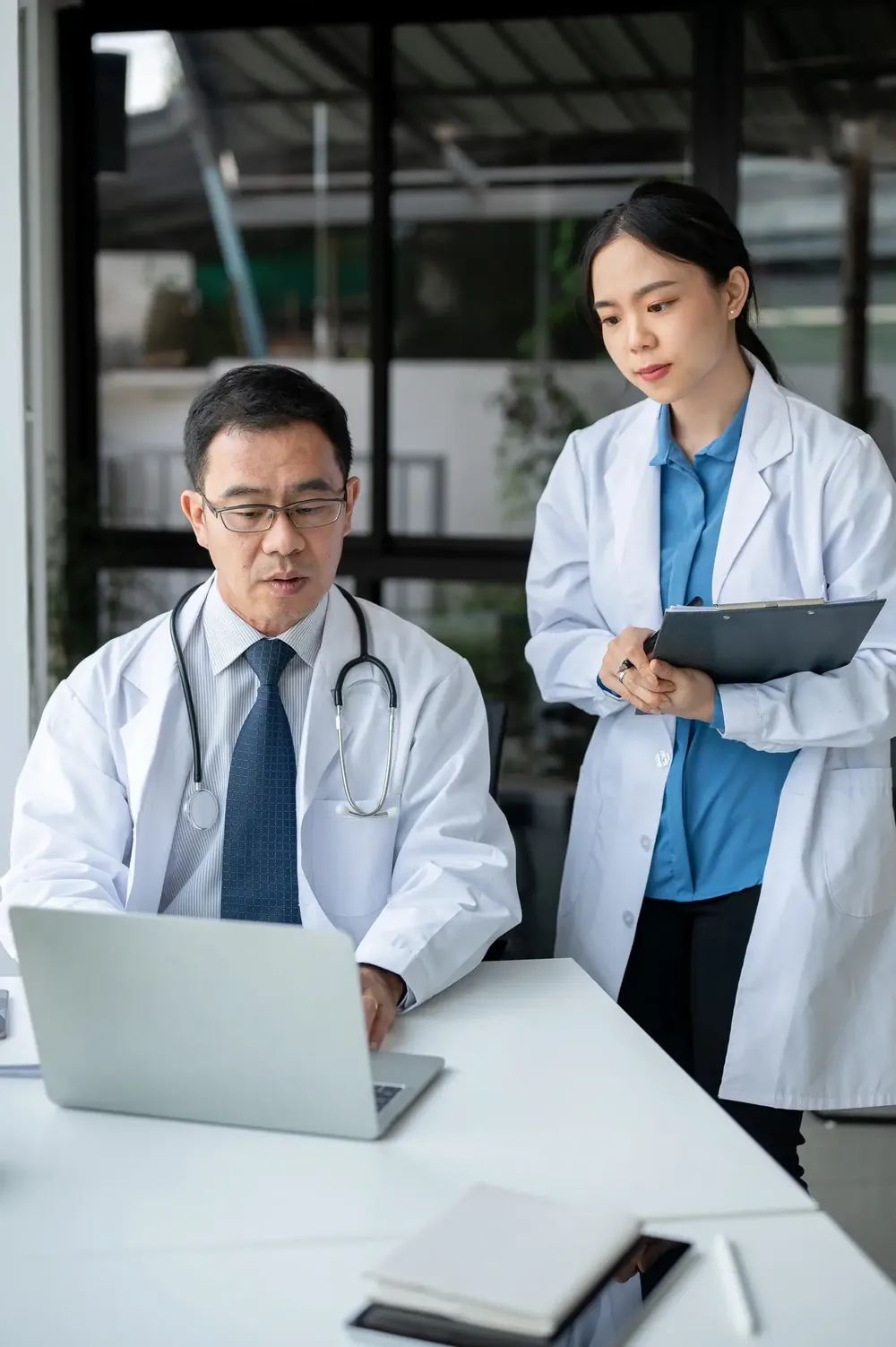 Two doctors reviewing a patient's history