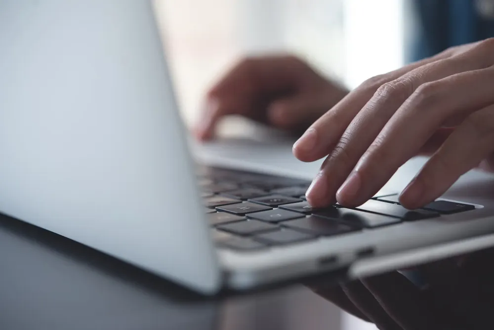 Person typing on a keyboard making a website