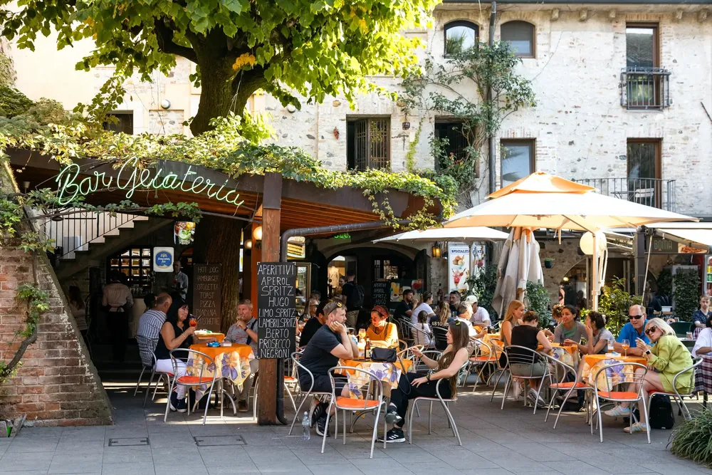Outdoor dining area full of people eating