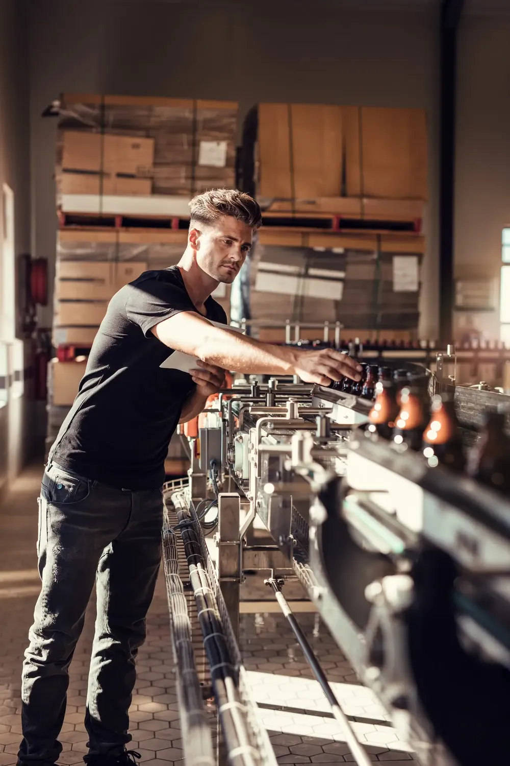 Man bottling beer in his facility