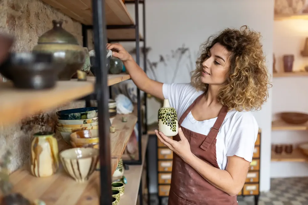 Woman reorganizing her merchandise on a shelf
