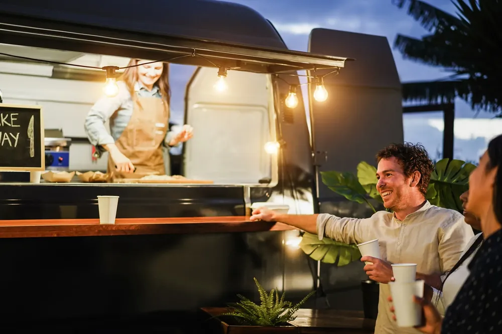 Coffee truck owner serving customers